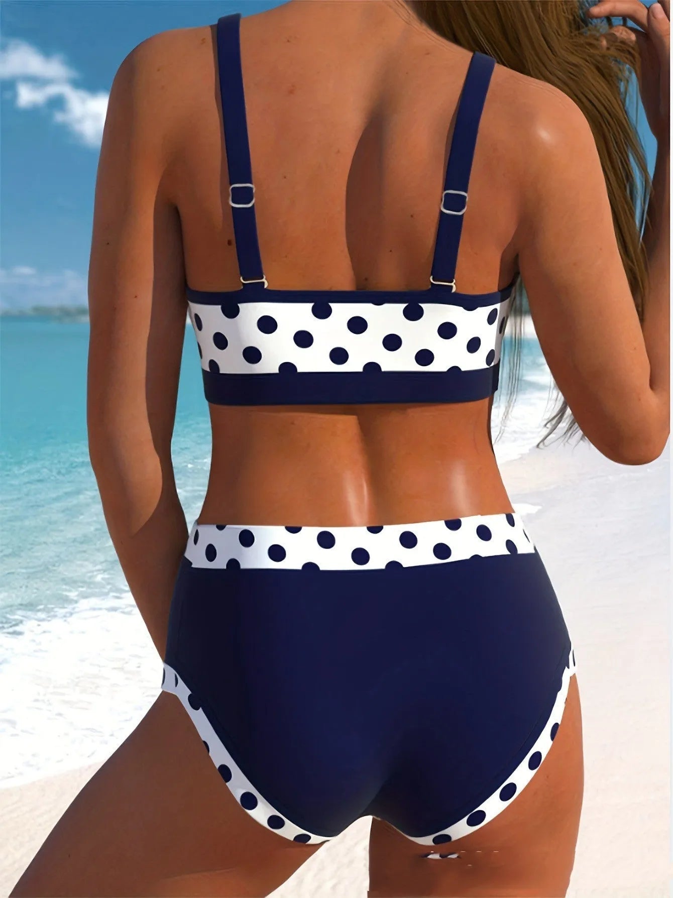 Women's two-piece swimsuit with small wave dot pattern and brief-style bottoms.