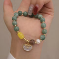 Women's casual bracelet with a single green jade bead on an adjustable band.