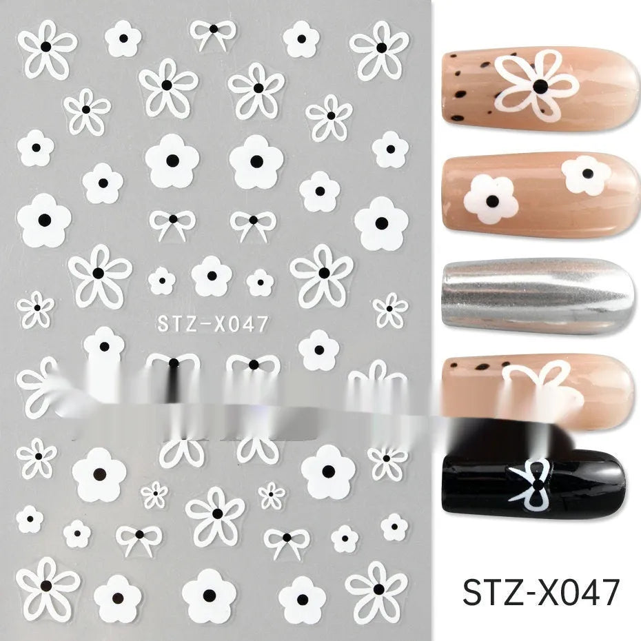 Plastic sheet of black, silver, and cartoon design nail art stickers for DIY manicures.