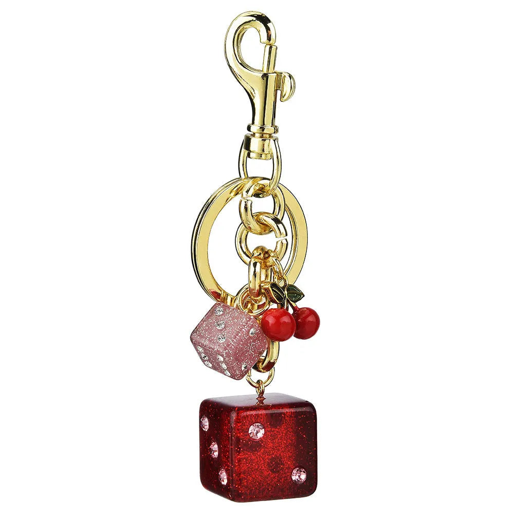 Square metal keychain pendant with a cerise two-tone dice pattern.