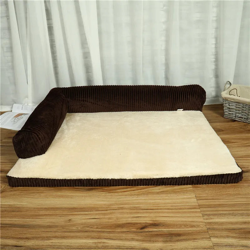 Grey corduroy dog sofa bed with raised sides on a wooden floor, showing its non-slip base.