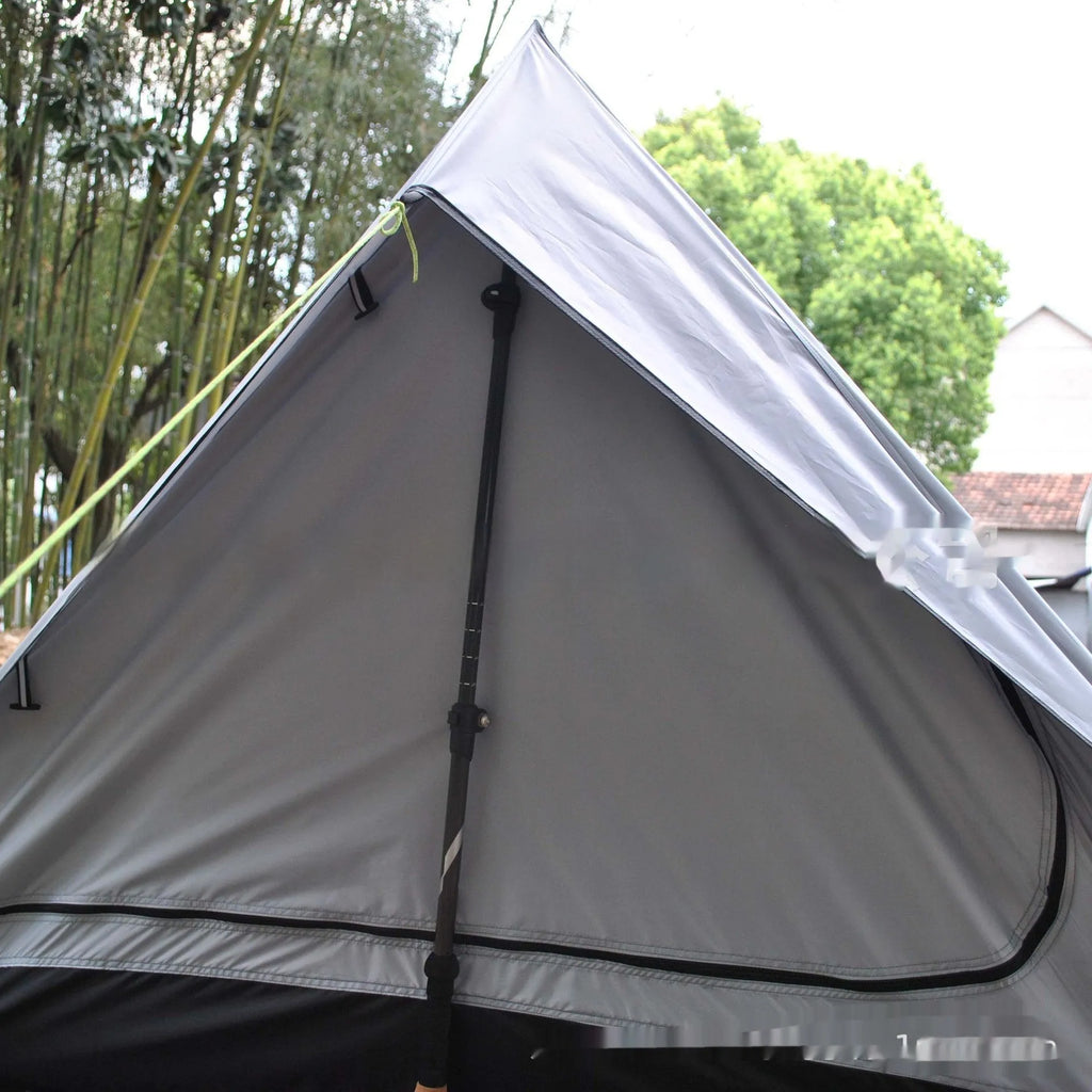 Brown or white A-line hiking tent without poles, supported by hiking canes