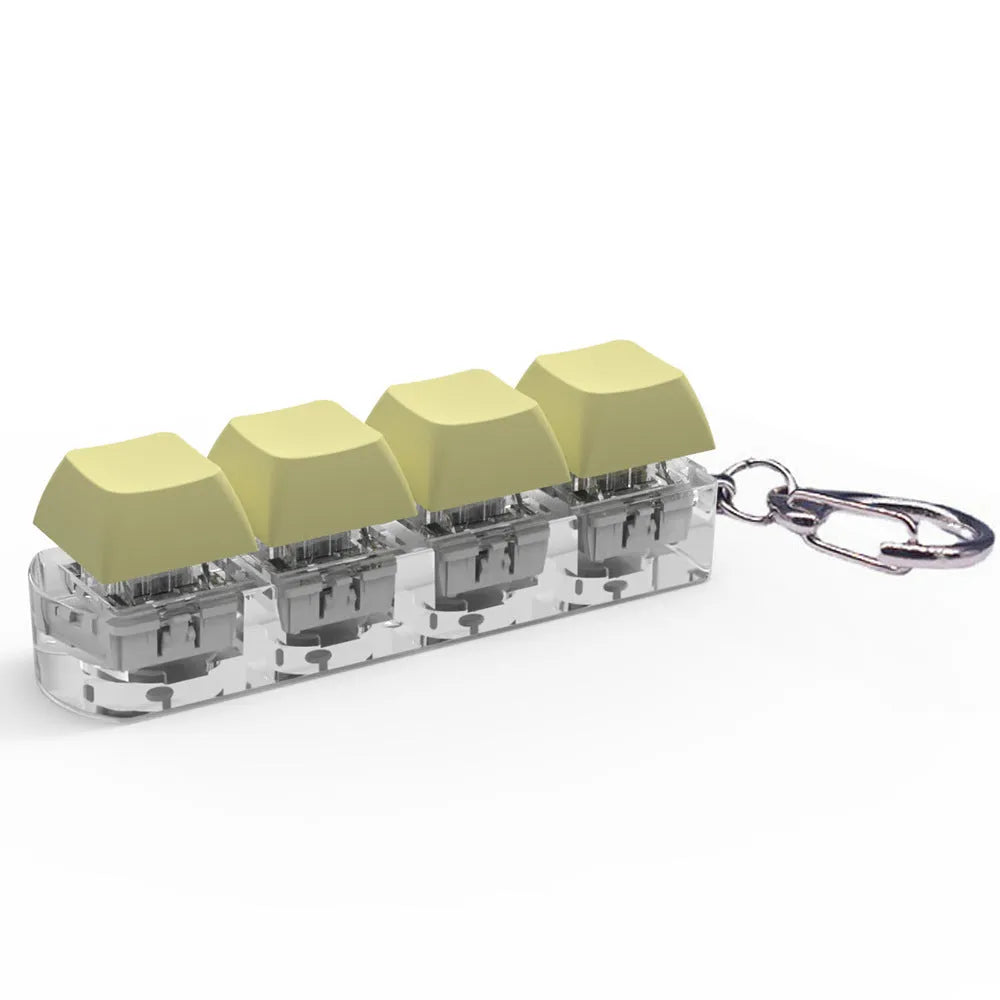 Four-key mechanical keyboard switch tester made of ABS plastic on a desk.