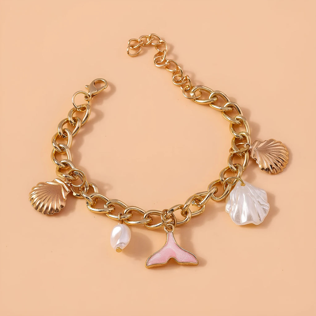 Women's white pearl alloy shell pearl mermaid tail bracelet on neutral background