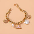 Women's white pearl alloy shell pearl mermaid tail bracelet on neutral background