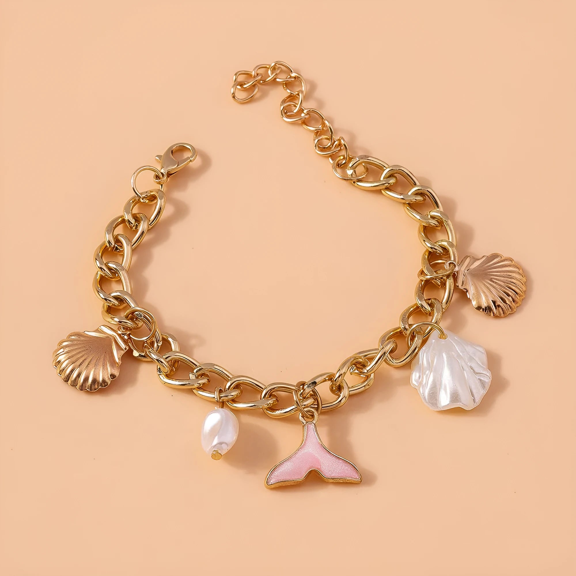 Women's white pearl alloy shell pearl mermaid tail bracelet on neutral background