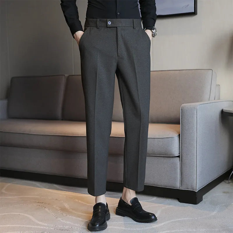 Men's straight leg brown corduroy trousers with an elasticated waistband on a hanger