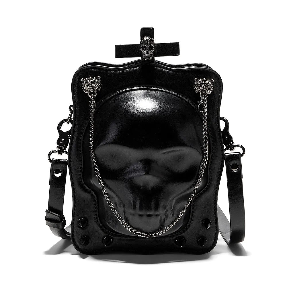 Black mini square crossbody bag with skull embossing, chain detail, and metal rivets on a vertical PU leather messenger bag.