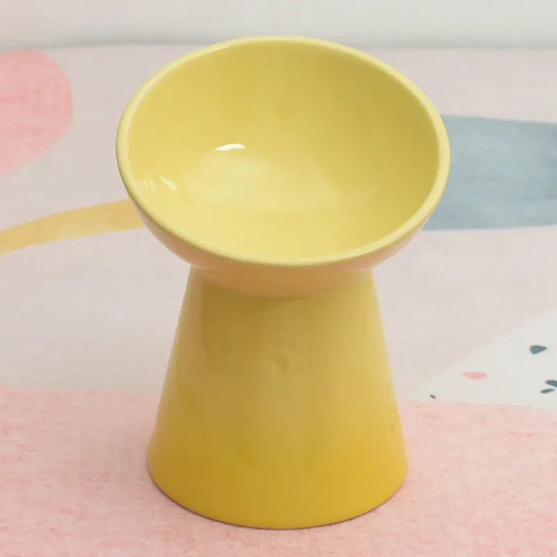 A white ceramic pet bowl with a high foot and raised neck protector to prevent tipping.