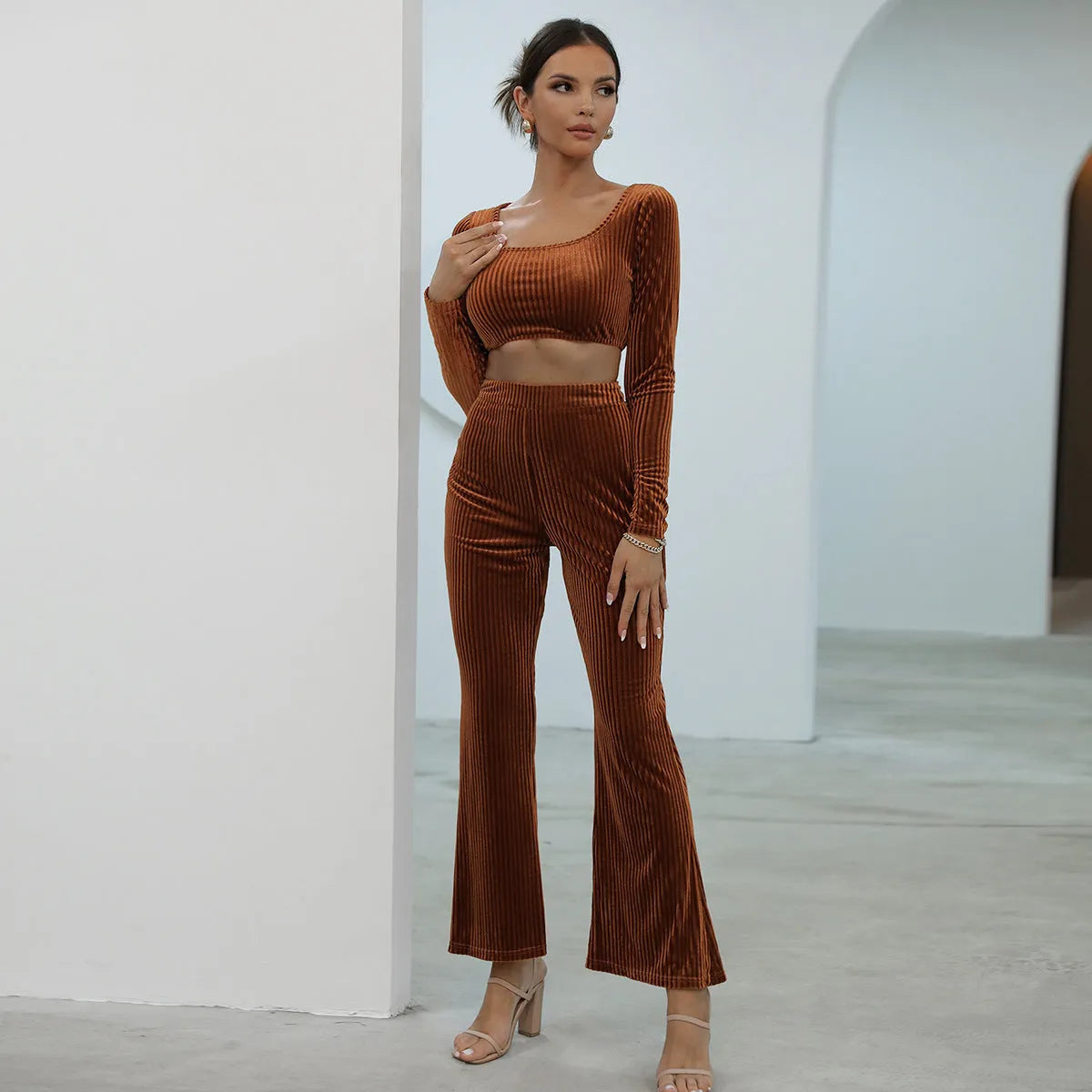 Women's caramel coloured long sleeve sweater and trousers loungewear set on a hanger.