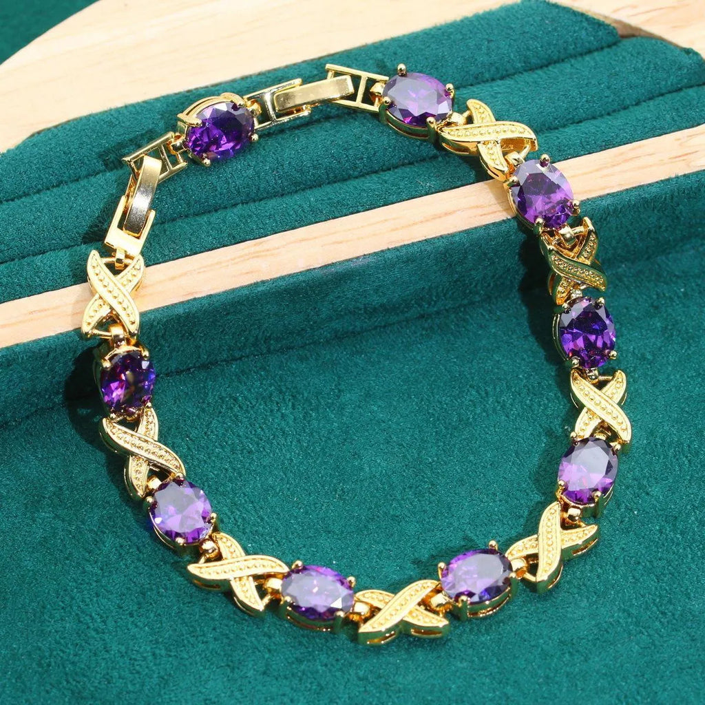 18k gold plated zircon jewellery set showing necklace, earrings, bracelet, and ring with sparkling cubic zirconia stones