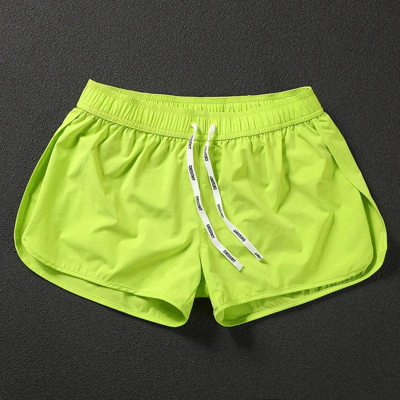 Men's loose beach shorts in orange, fluorescent green, and black colours with elastic waist