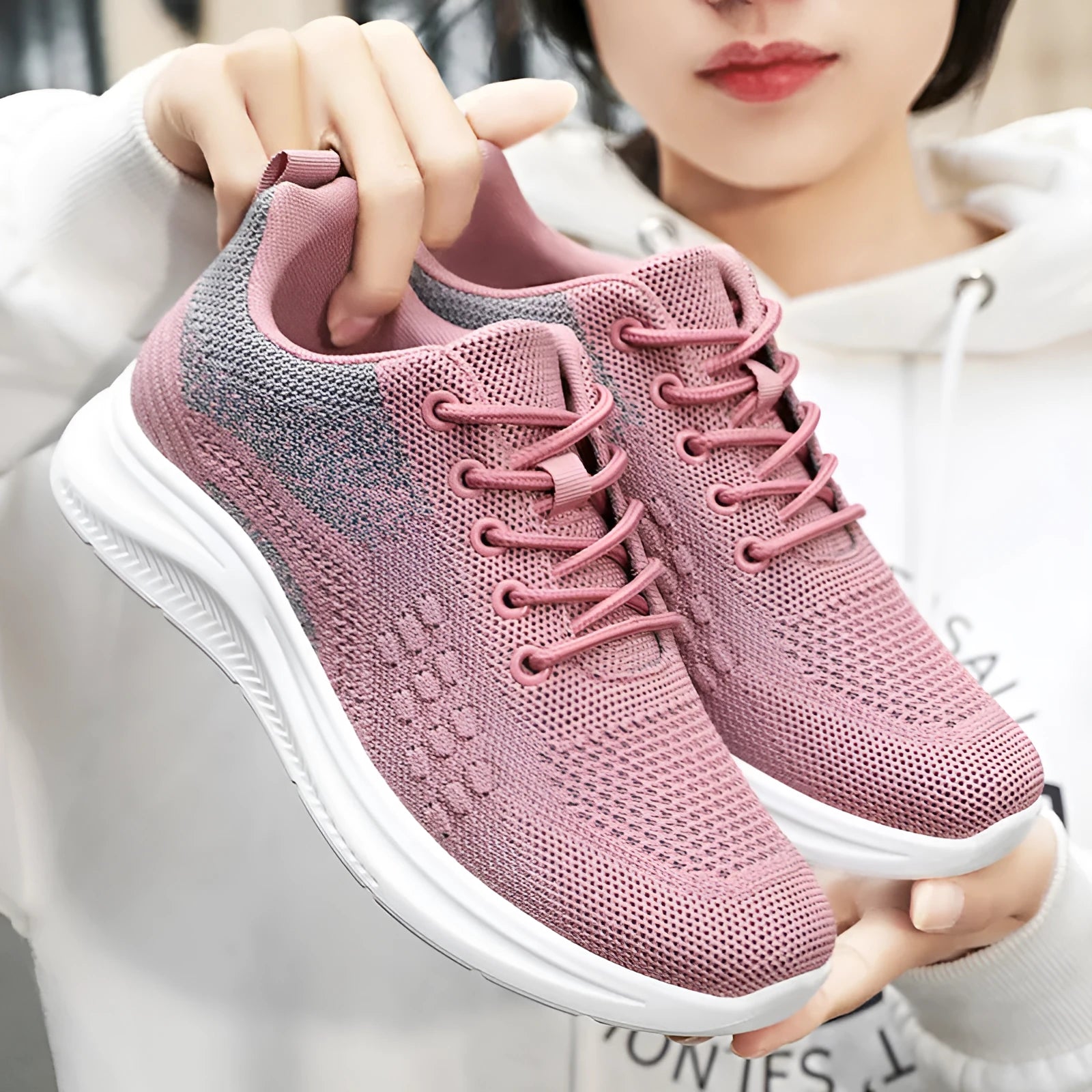 Women's low-top lace-up sneakers in black with breathable mesh upper and soft PVC sole