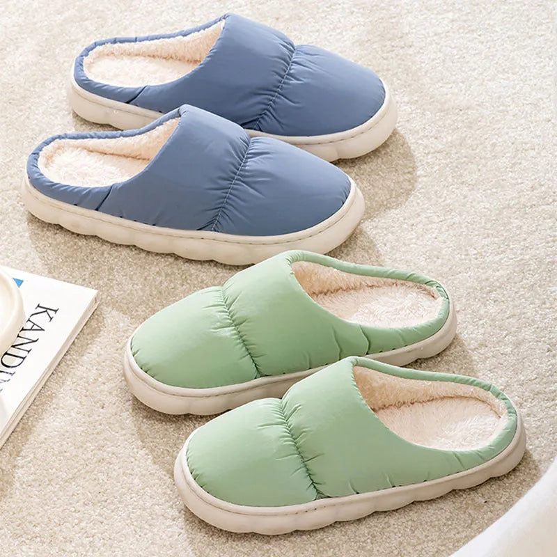 Pair of down cotton indoor slippers with artificial leather upper and thick rubber sole.