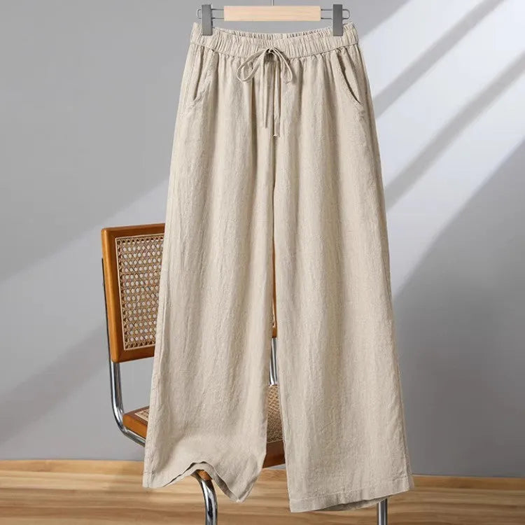 Women's apricot straight-leg casual trousers with an elastic lace-up waistband on a hanger.