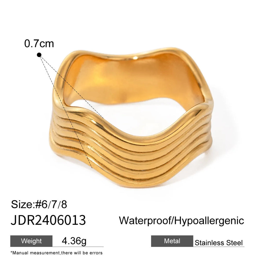 Stainless steel women's ring with a wide geometric wave surface design in a silver or gold finish.
