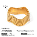 Stainless steel women's ring with a wide geometric wave surface design in a silver or gold finish.
