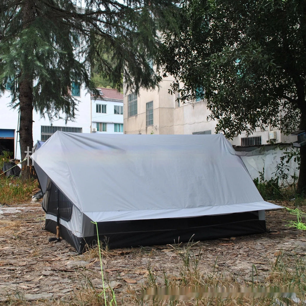 Brown or white A-line hiking tent without poles, supported by hiking canes
