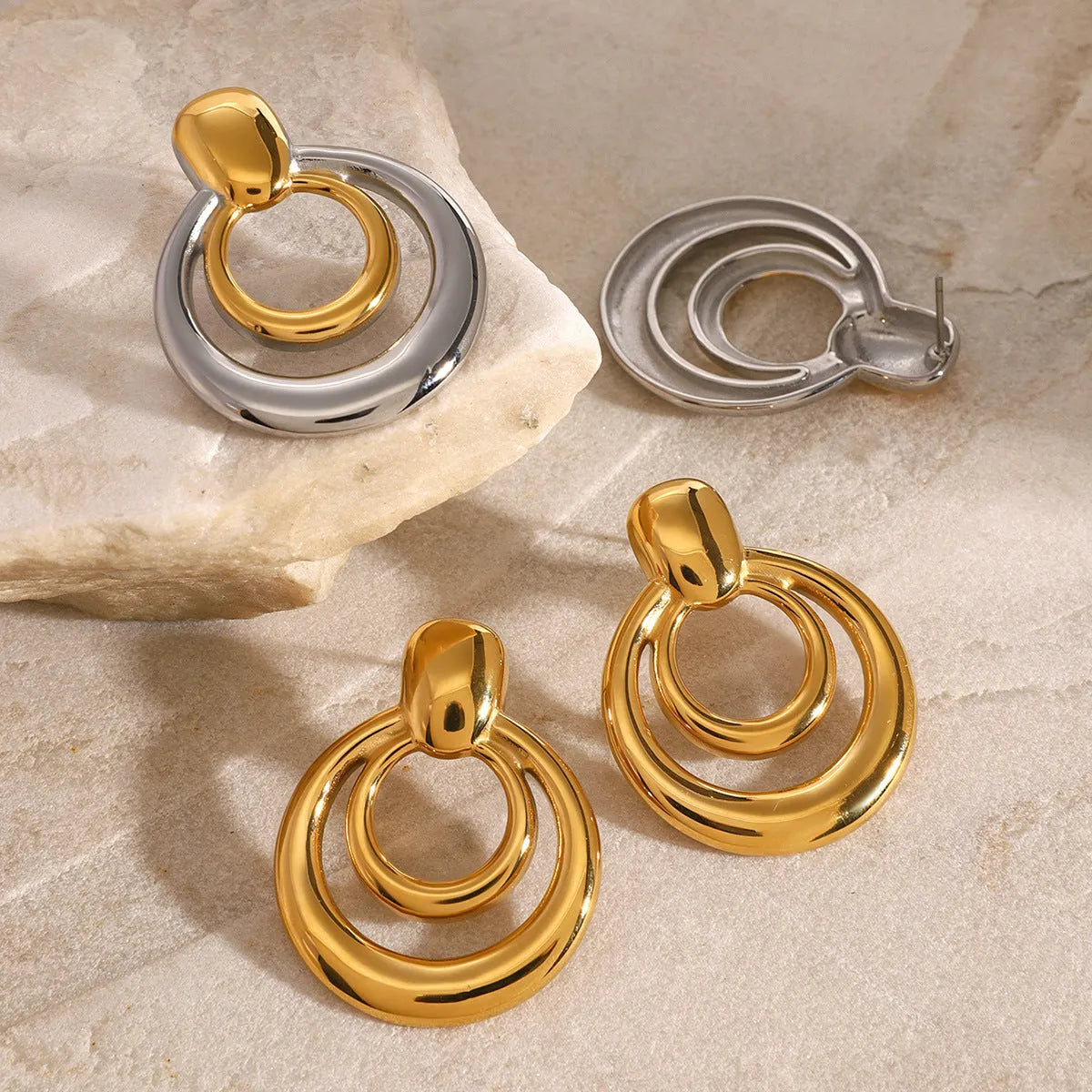 Golden round titanium steel hollow stud earrings with double layer construction and hypoallergenic properties