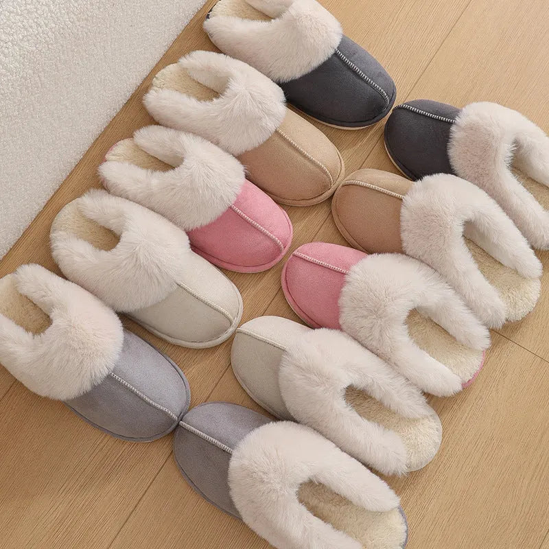 Women's brown plush indoor slippers with round toe, flat heel, and decorative stitching.