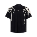 Black loose-fit short-sleeved t-shirt with padded shoulder detail and ribbed cotton texture.
