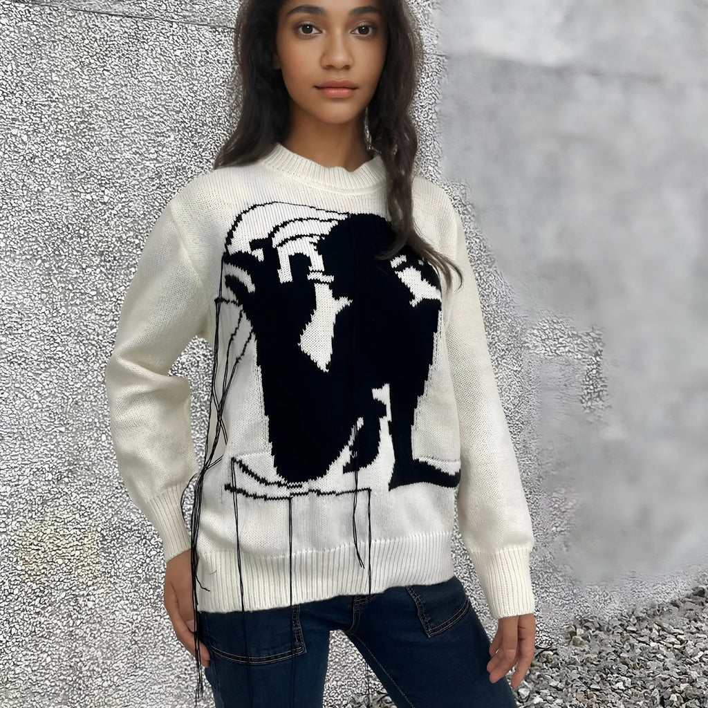 Grey women's loose alpaca wool sweater with a round neck, regular sleeves, and a long tassel detail.
