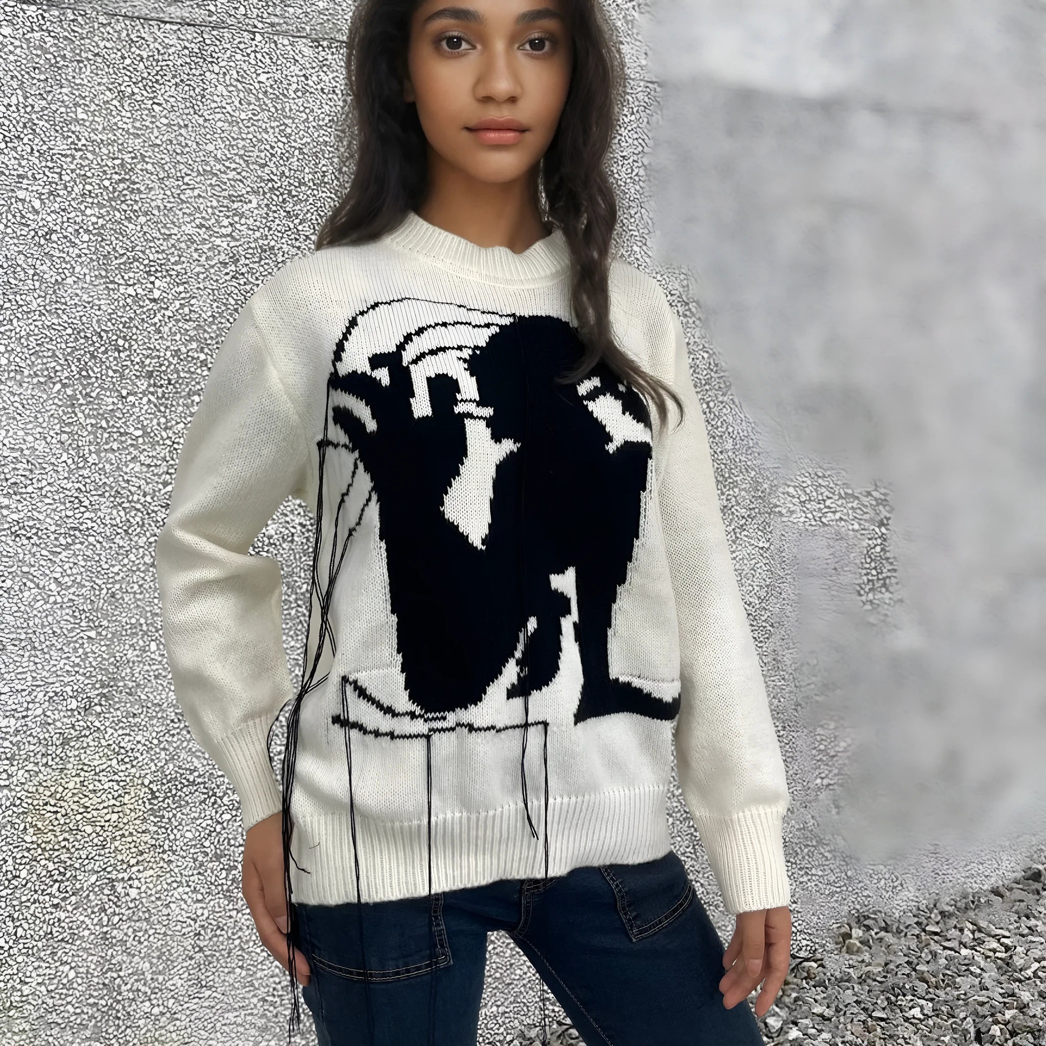 Grey women's loose alpaca wool sweater with a round neck, regular sleeves, and a long tassel detail.
