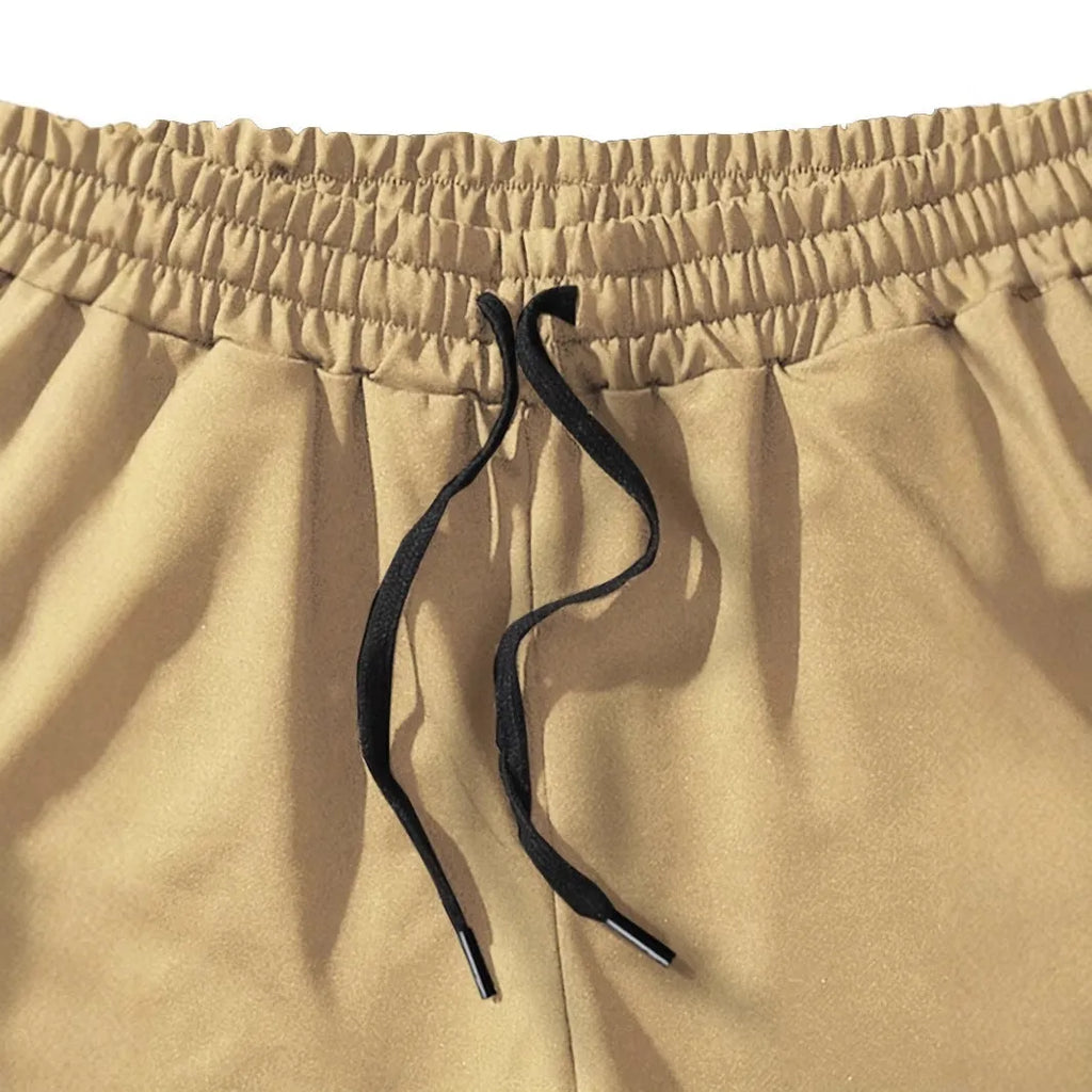 Men's khaki coconut print sports shorts with straight cut design and micro-elastic polyester fabric