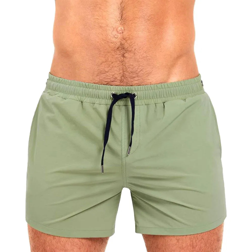 Polyester sports shorts with mesh lining in Army Green colour on a white background.