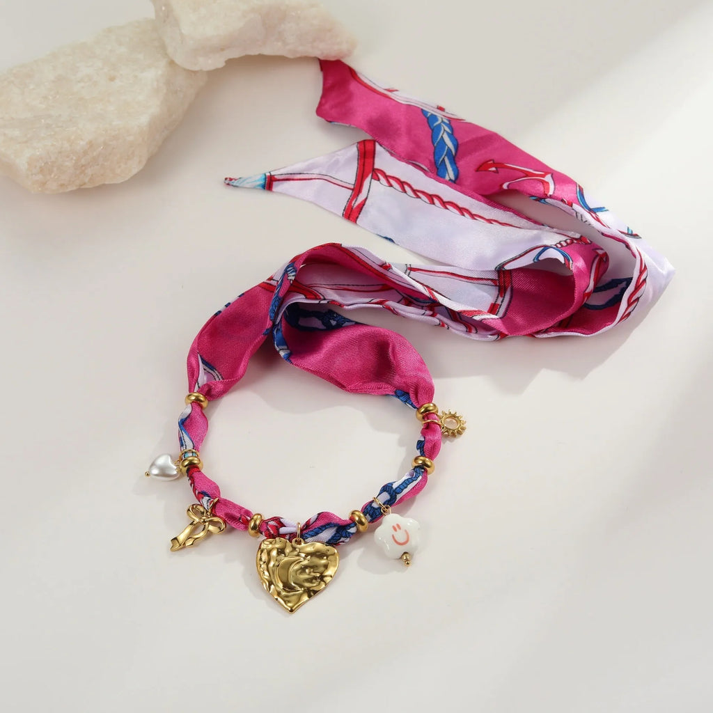 Stainless steel geometric pendant necklace and matching bracelet set with gold electroplating on a white background.