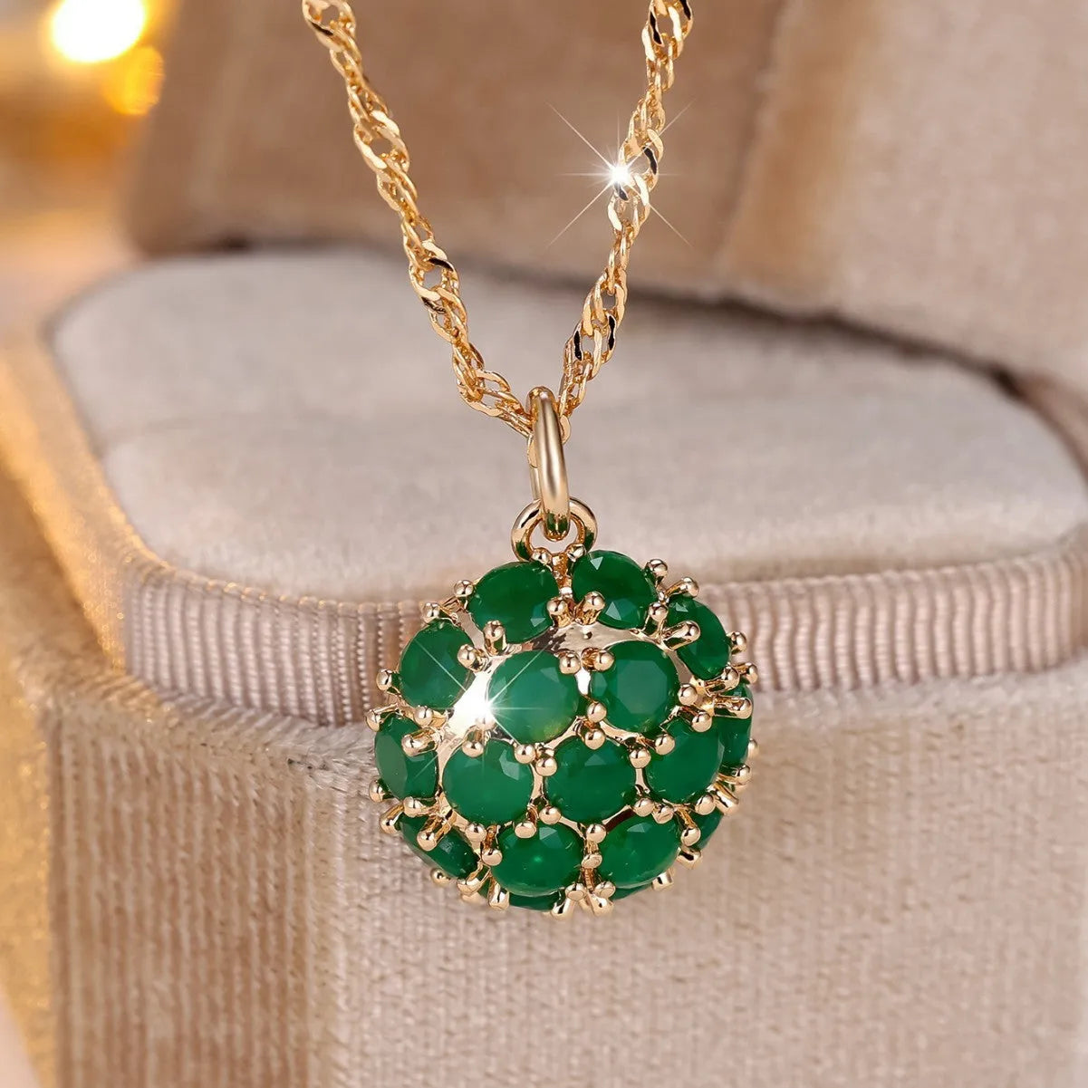 Round emerald pendant with full diamond setting on champagne gold chain necklace