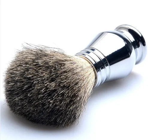 CSB men's shaving kit with chrome stand holding a double edge razor and badger hair brush, plus soap bowl and blades.
