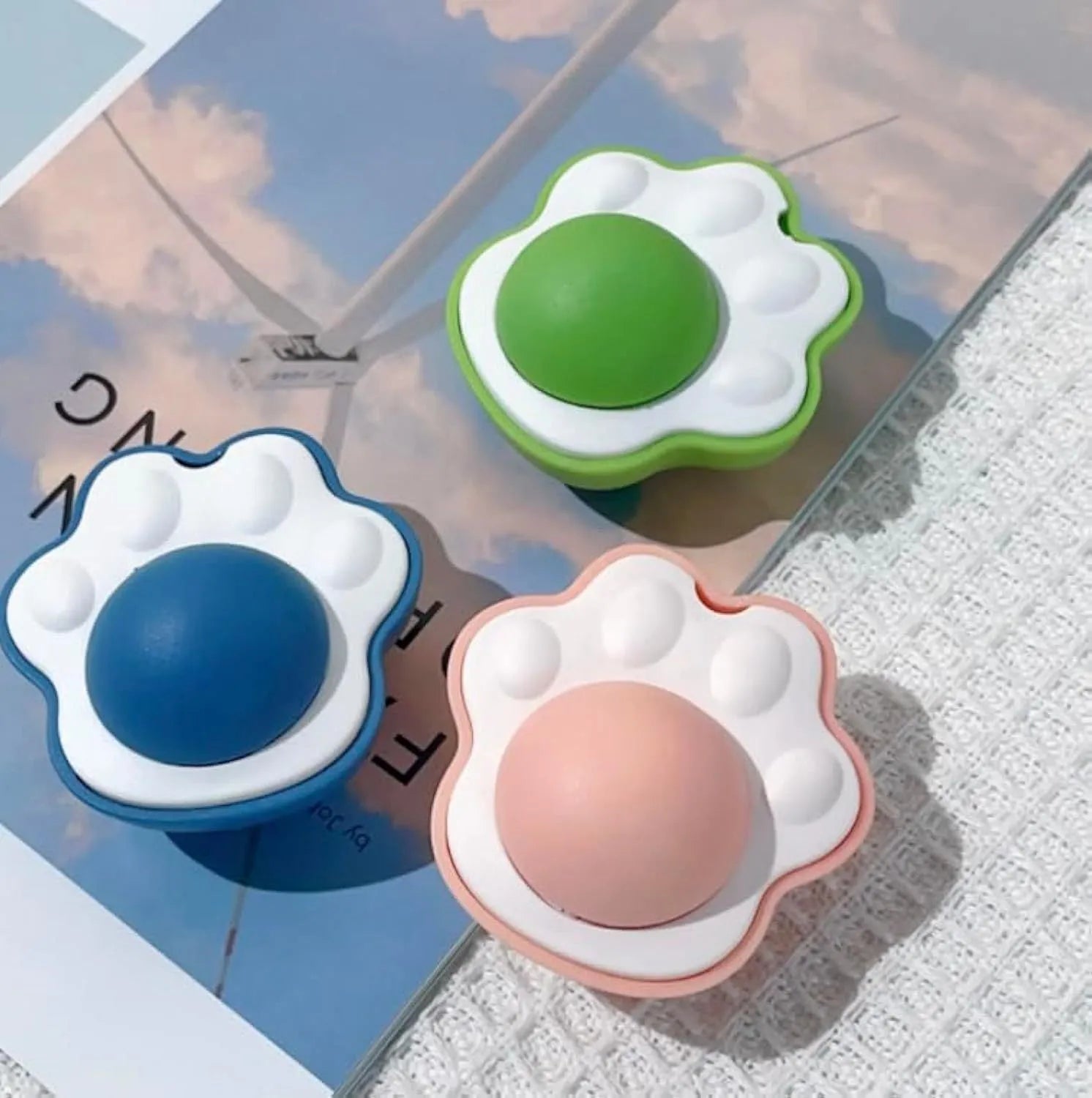 Blue plush catnip mouse toy with edible lick surface for dental health, shown next to a green and pink version.