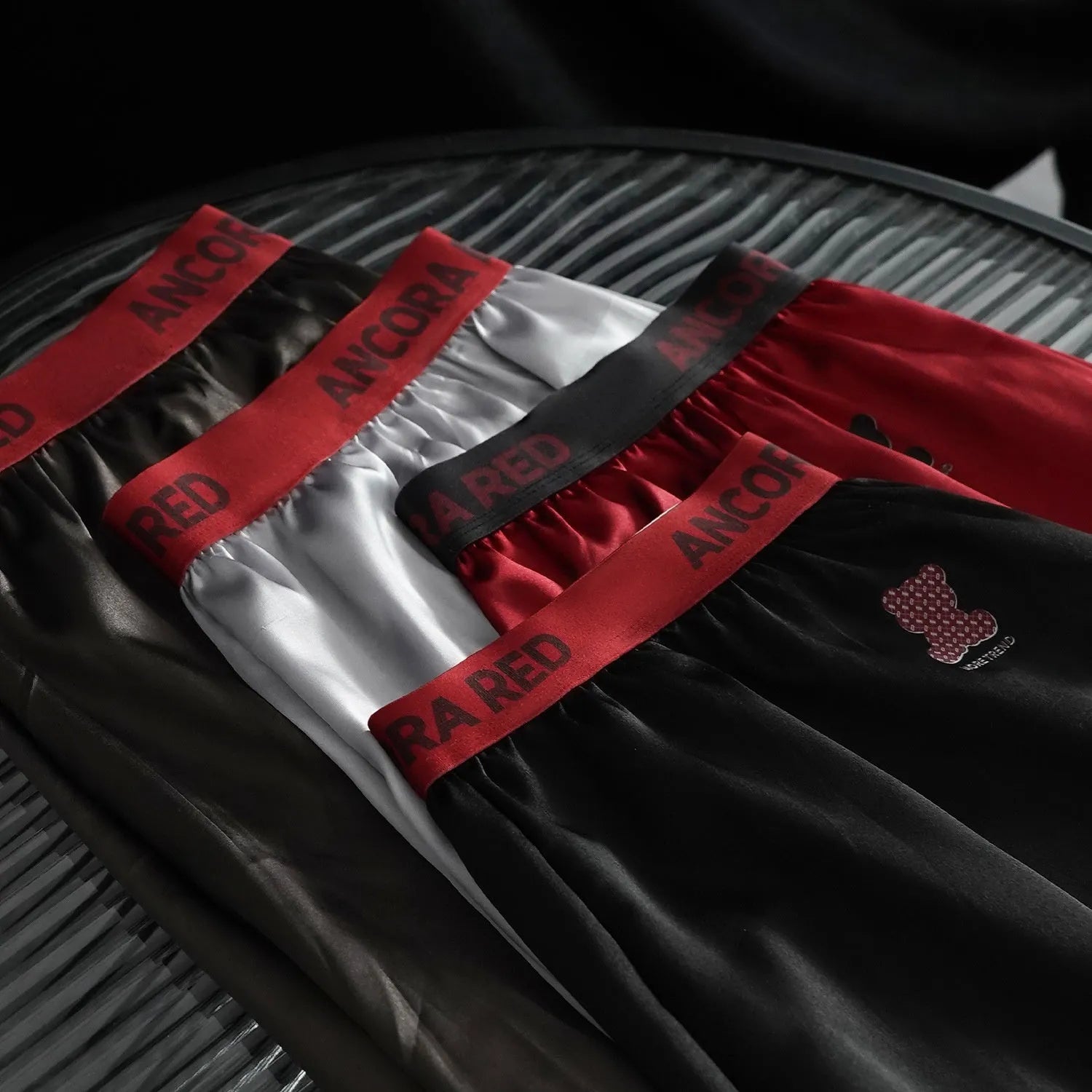 Men's solid colour boxer briefs in black, red, blue, silver, purple and brown on a mid-waist design.