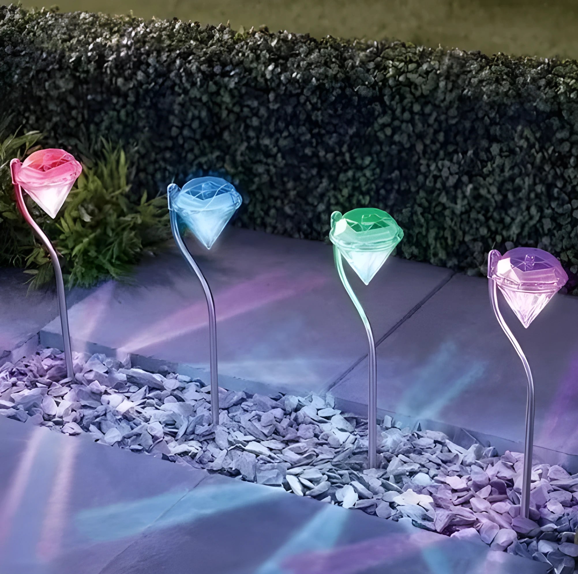 White solar-powered garden spotlight with adjustable head and solar panel on a stake for outdoor installation.