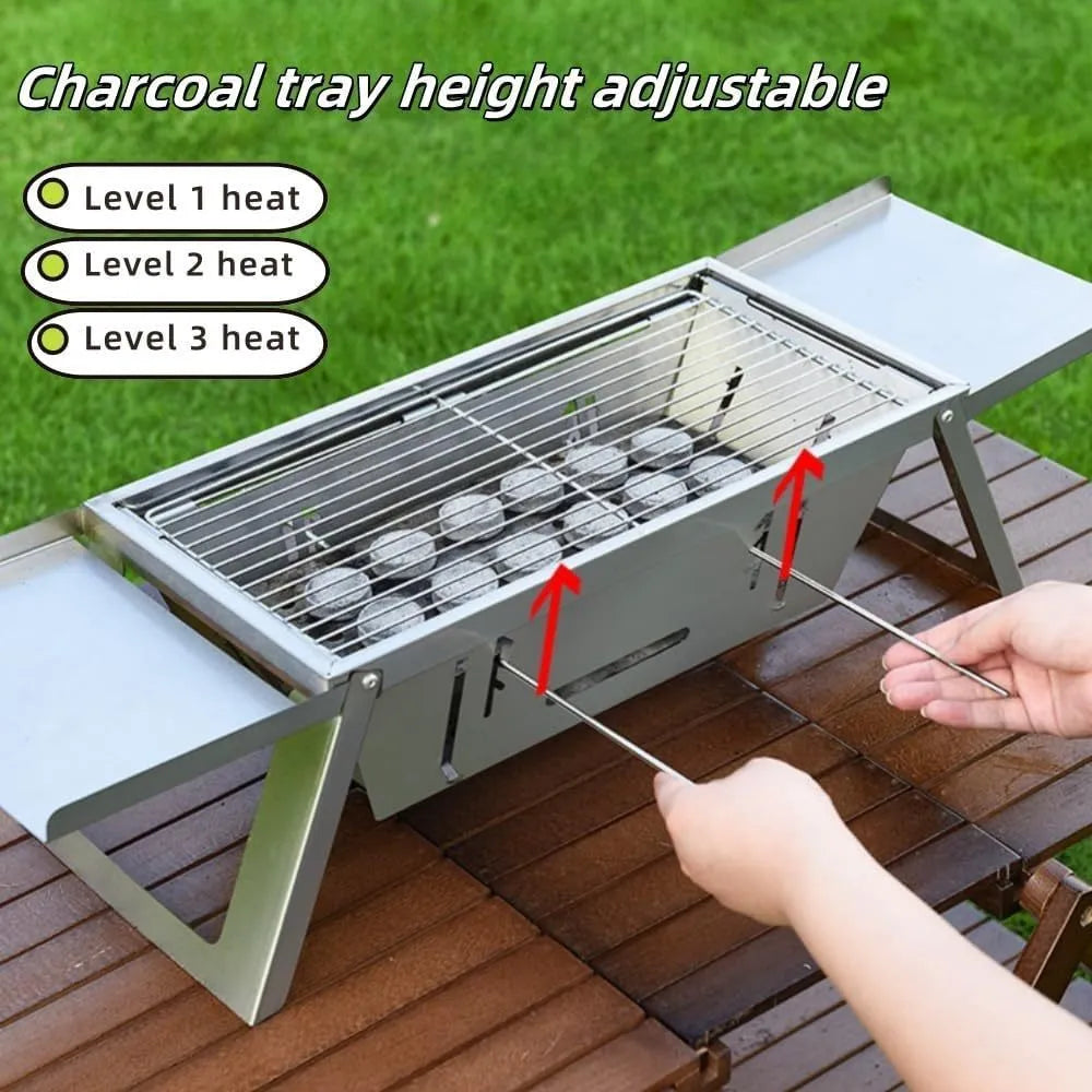 Small foldable portable charcoal grill shown in an outdoor setting.