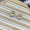 Minimalist irregular zircon stud dangle earrings in gold colour on a white background