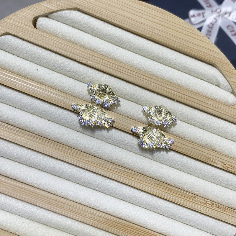 Minimalist irregular zircon stud dangle earrings in gold colour on a white background