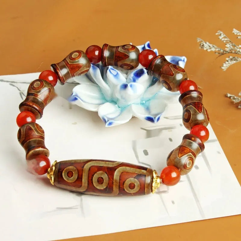 Agate Tibetan dzi bead bracelet with three-eye design and polished finish