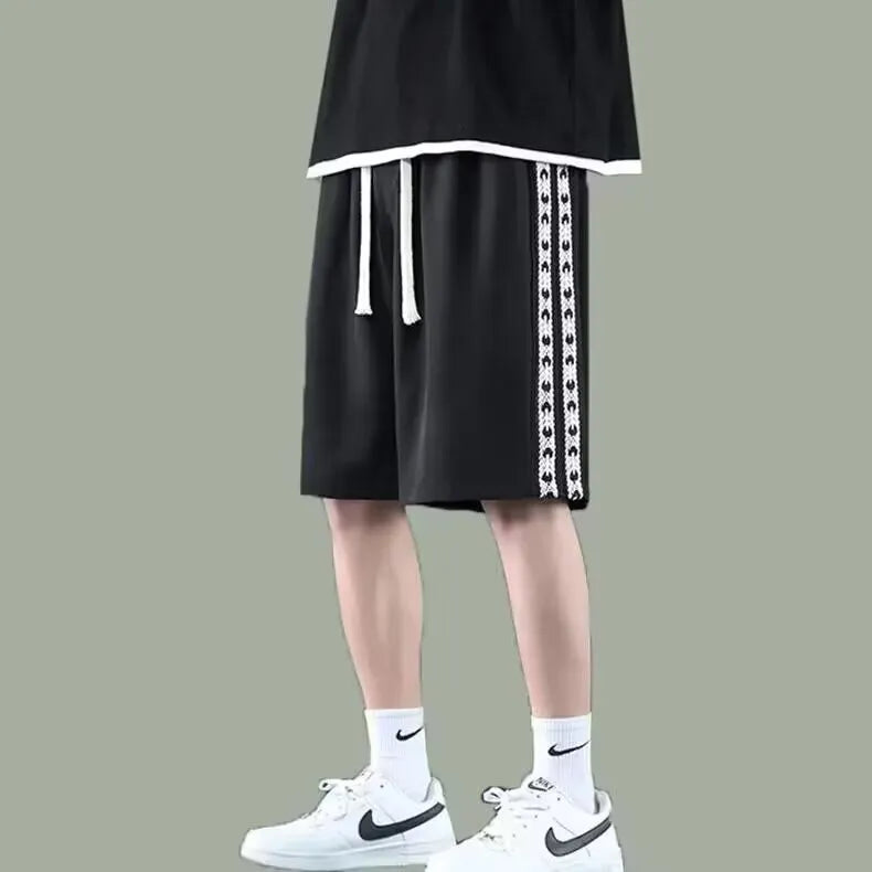 Men's loose-fitting track pants in grey with elastic waistband and baggy leg design