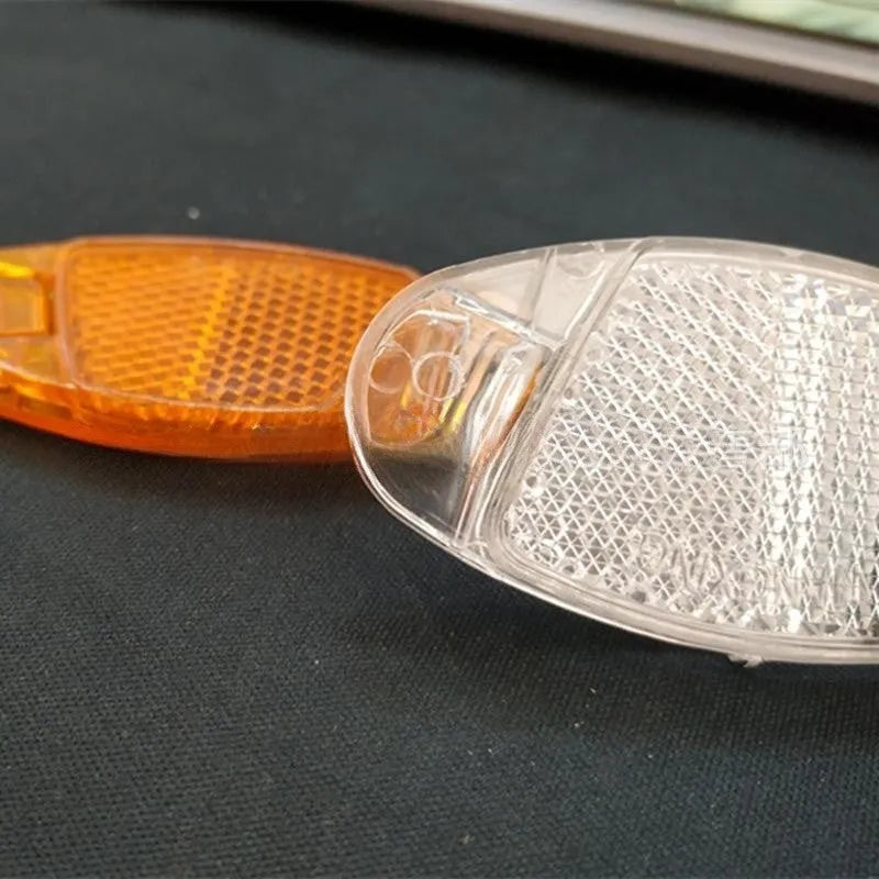 White and yellow plastic bicycle spoke reflector decorations for front and rear wheel safety