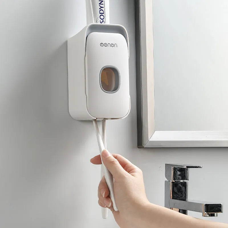 Automatic toothpaste dispenser mounted on bathroom wall in blue colour