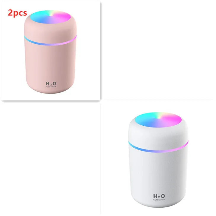 Pink USB portable humidifier with 300ml water tank on wooden desk surface