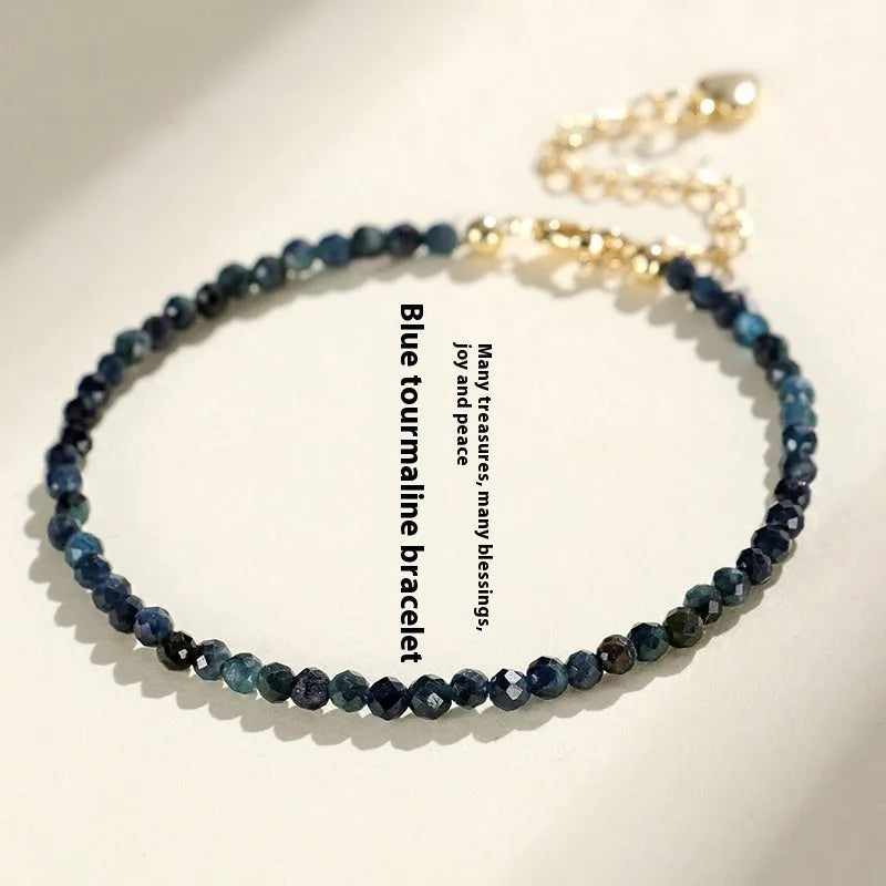 Women's blue tourmaline bracelet with 3mm beads and gold spacer beads