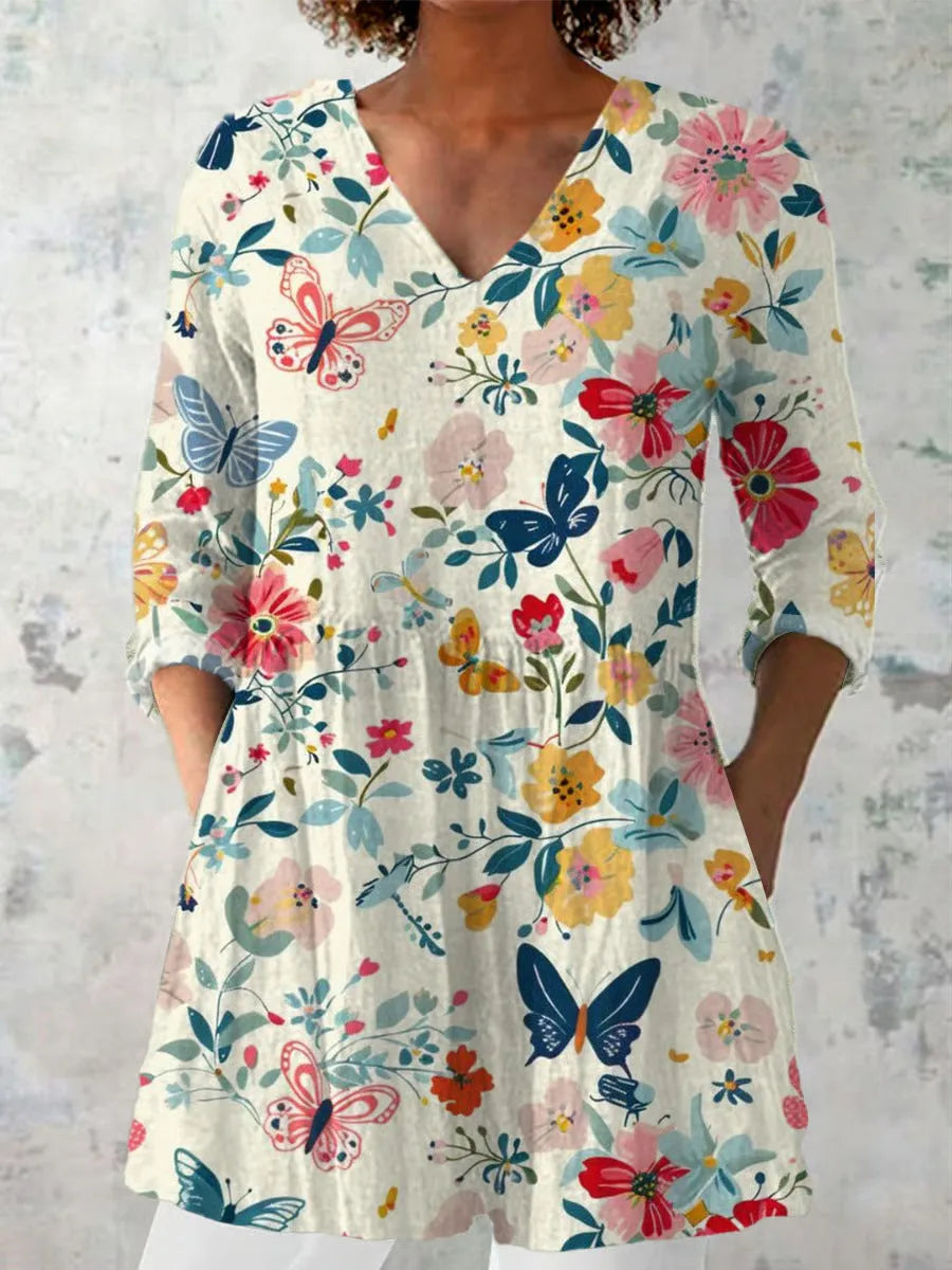 Woman wearing a retro slim fit, digitally printed long-sleeved top in a floral design.