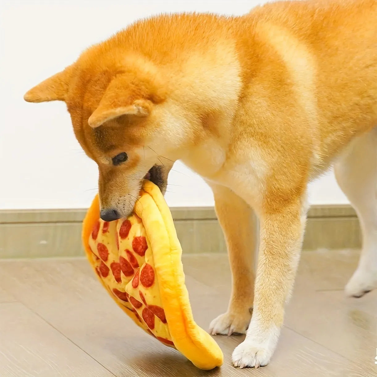 Yellow pizza slice shaped dog chew toy with textured pepperoni and crust details