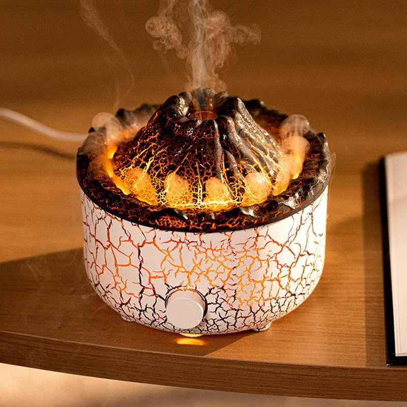 Volcano humidifier with LED lights and mist creating a fiery flame effect, column-shaped plastic body on a table