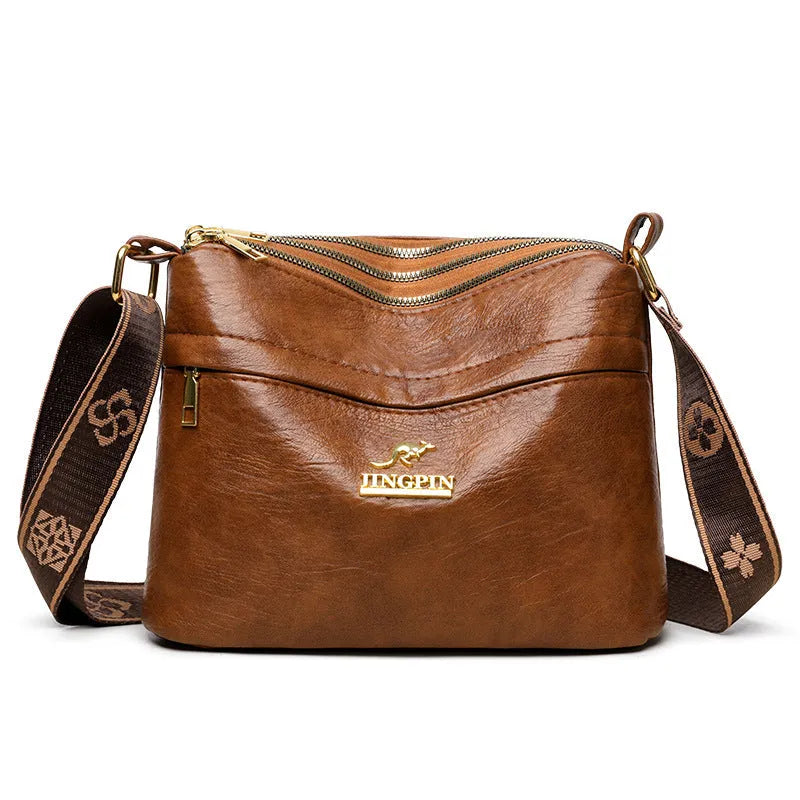 Large capacity multi compartment cross body bag in black with horizontal square shape and sewing thread detail