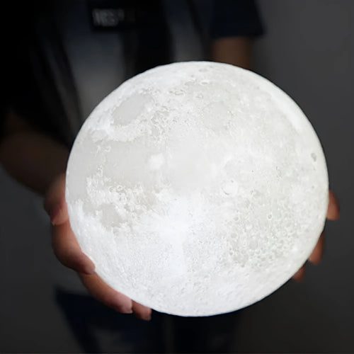 3D printed white moon lamp on wooden stand with colour-changing LED light