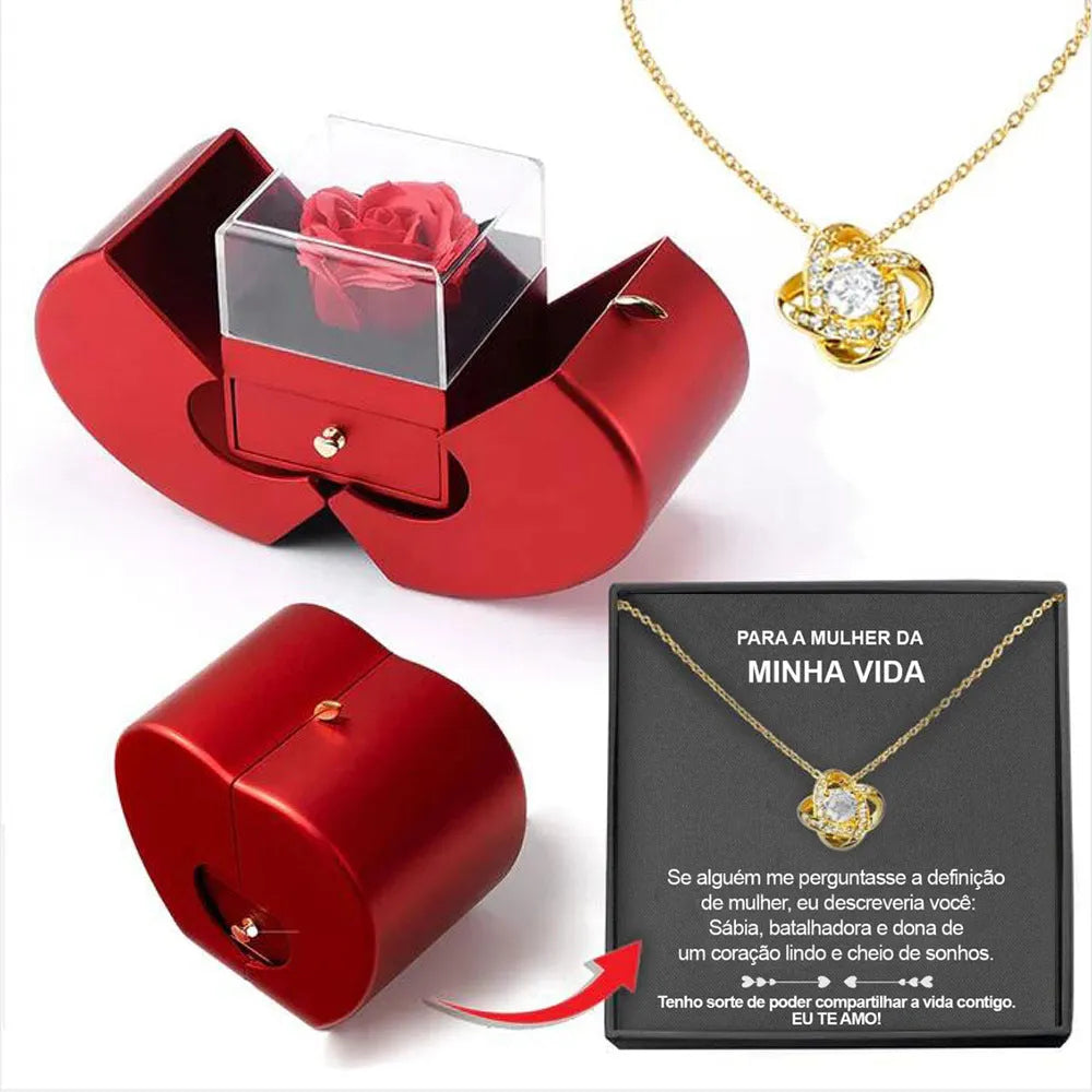Red apple-shaped jewelry box with eternal soap flower rose and silver necklace inside